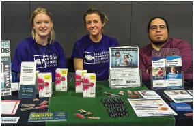 photo of Outreach and Education specialists Rachel Larson and Brooke Cowden offering information and a range of Health District services along with Roy Ramirez, prescription assistance and health coverage specialist